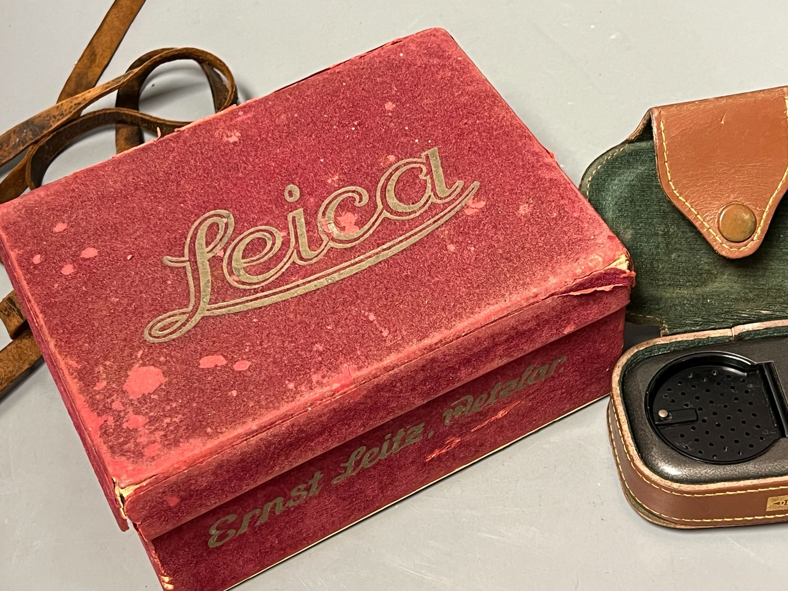 A cased Leica Ernst Leitz Wetzlar nr. 606583 camera together with light meter, lenses etc.